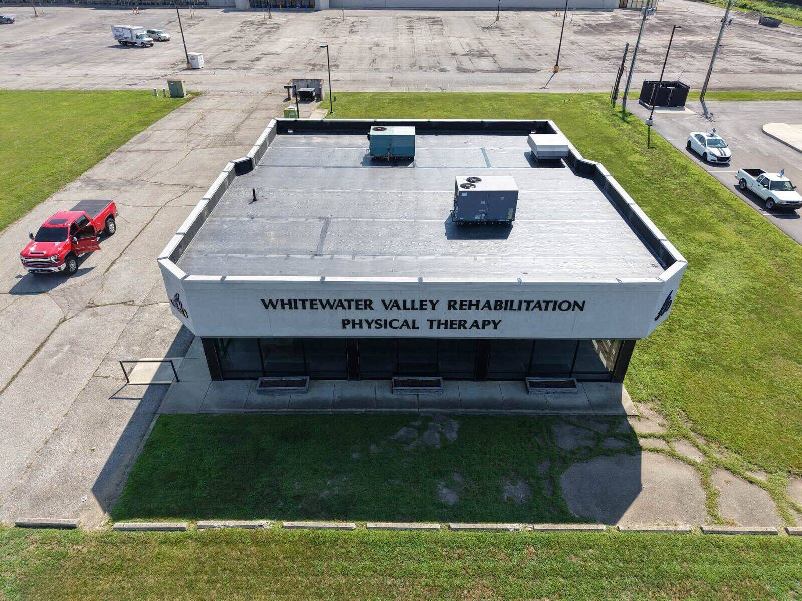 The same Connersville commercial building with its completed low-slope roof.